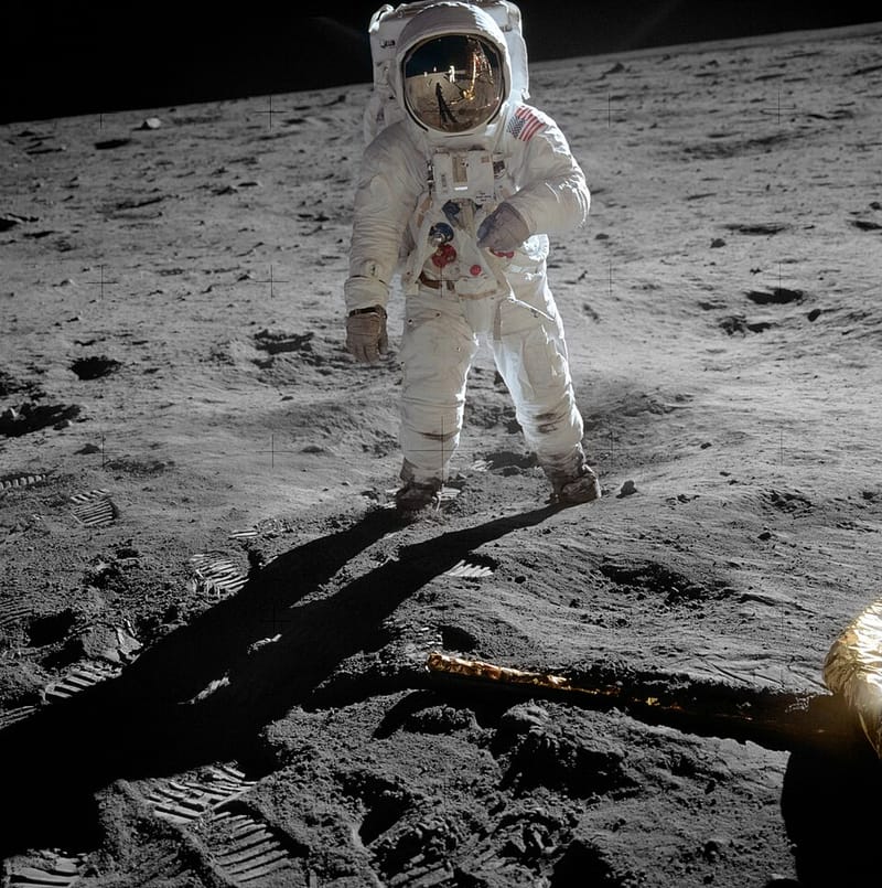 Buzz Aldrin standing on the Moon in his spacesuit