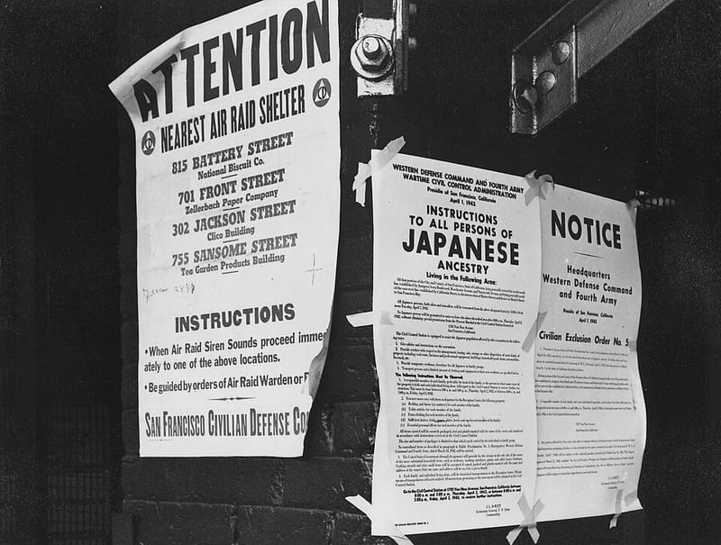 Exclusion orders posted on a brick wall at First and Front Streets, San Francisco, April 1942, directing the removal of people of Japanese ancestry